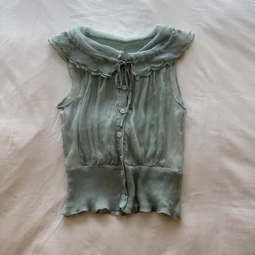 Green silk blouse with ruffled collar and button-up front